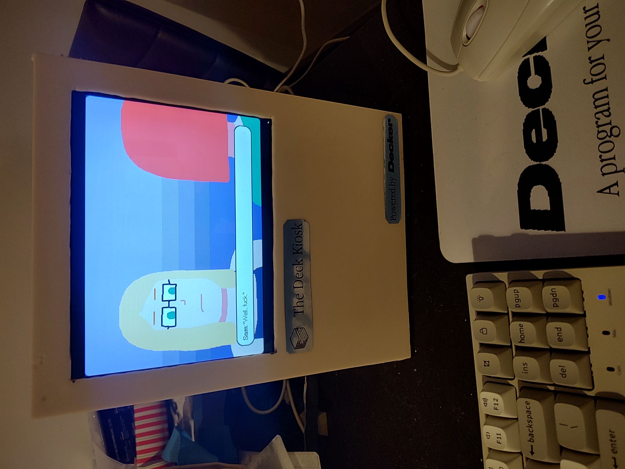 A game screenshot on the Deck Kiosk. A blonde lady named Sam says "Well... fuck" to a red-haired lady
