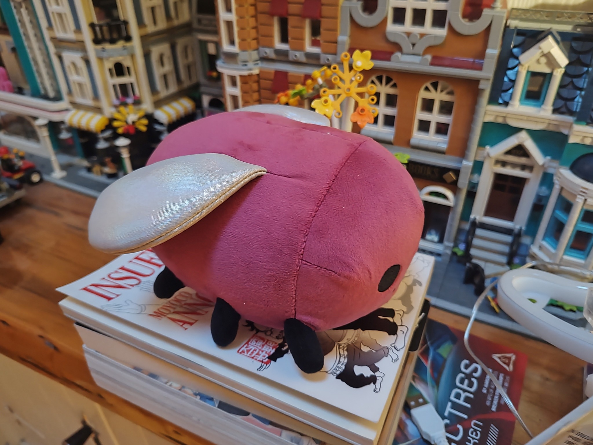 eggbug sits on some books