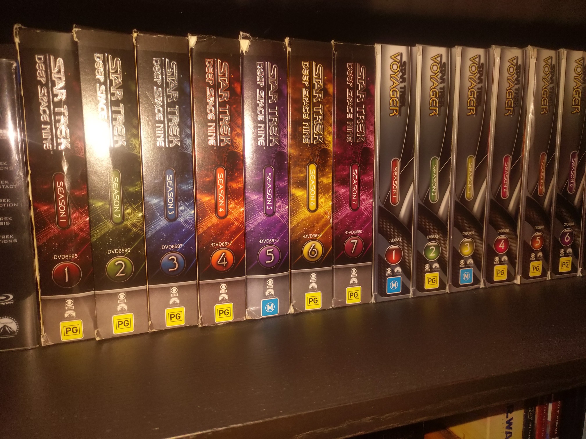 A shelf of Star Trek Deep Space Nine and Star Trek Voyager DVD boxsets